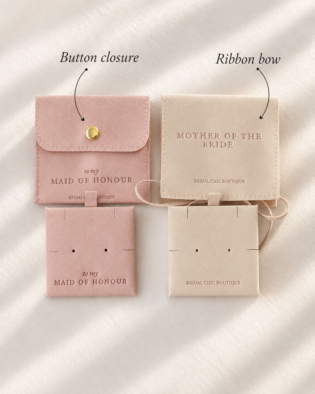 Two small fabric wedding keepsake pouches shown on a soft white draped background with callout labels. The left pouch is blush pink with a gold button closure and the text 'to my MAID OF HONOUR'; the right pouch is warm cream with a ribbon bow and the text 'MOTHER OF THE BRIDE'.